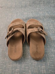 Michael Kors buckle slides featuring a signature logo monogram pattern