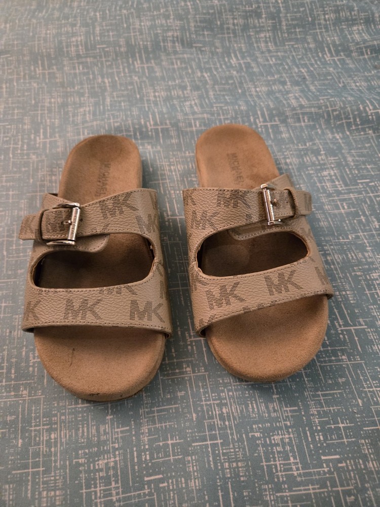 Michael Kors buckle slides featuring a signature logo monogram pattern