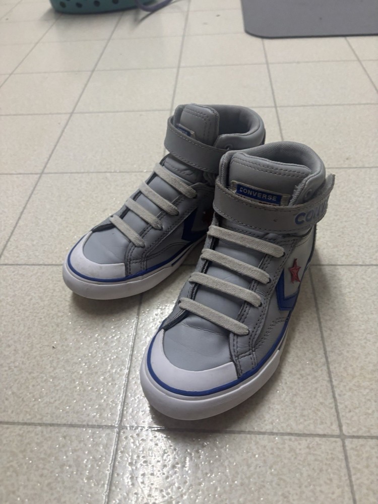 The image shows a pair of Converse Pro Blaze Strap Leather High Top sneakers