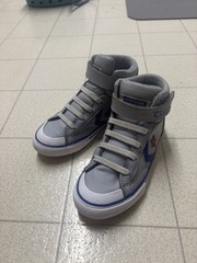 The image shows a pair of Converse Pro Blaze Strap Leather High Top sneakers