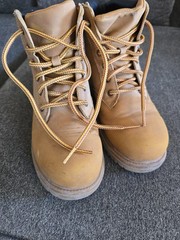 Timberland boots feature a classic wheat-colored nubuck upper and a black padded