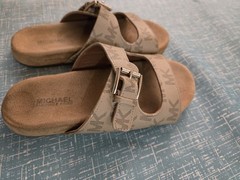 Michael Kors buckle slides featuring a signature logo monogram pattern