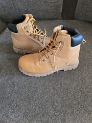 Timberland boots feature a classic wheat-colored nubuck upper and a black padded